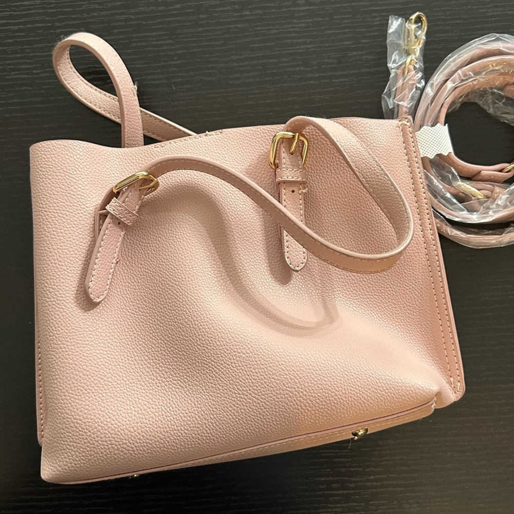 Small handbag with adjustable shoulder strap.